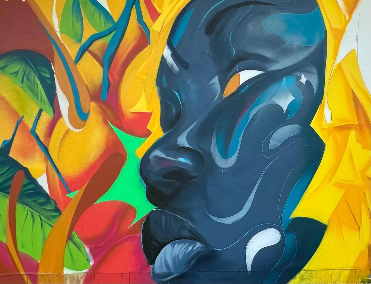 Vibrant Jamaican artwork at the Cultural Exchange Artist Demonstration Tent