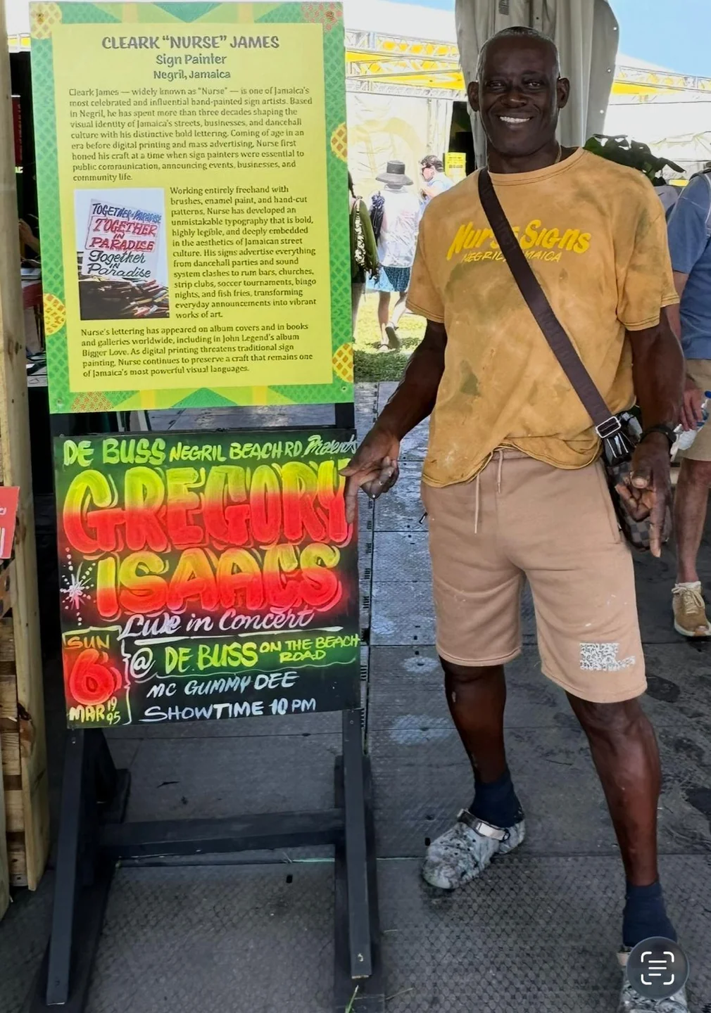 Cleark Nurse James and his hand-painted Jamaican signs at the Cultural Exchange Artist Demonstration Tent